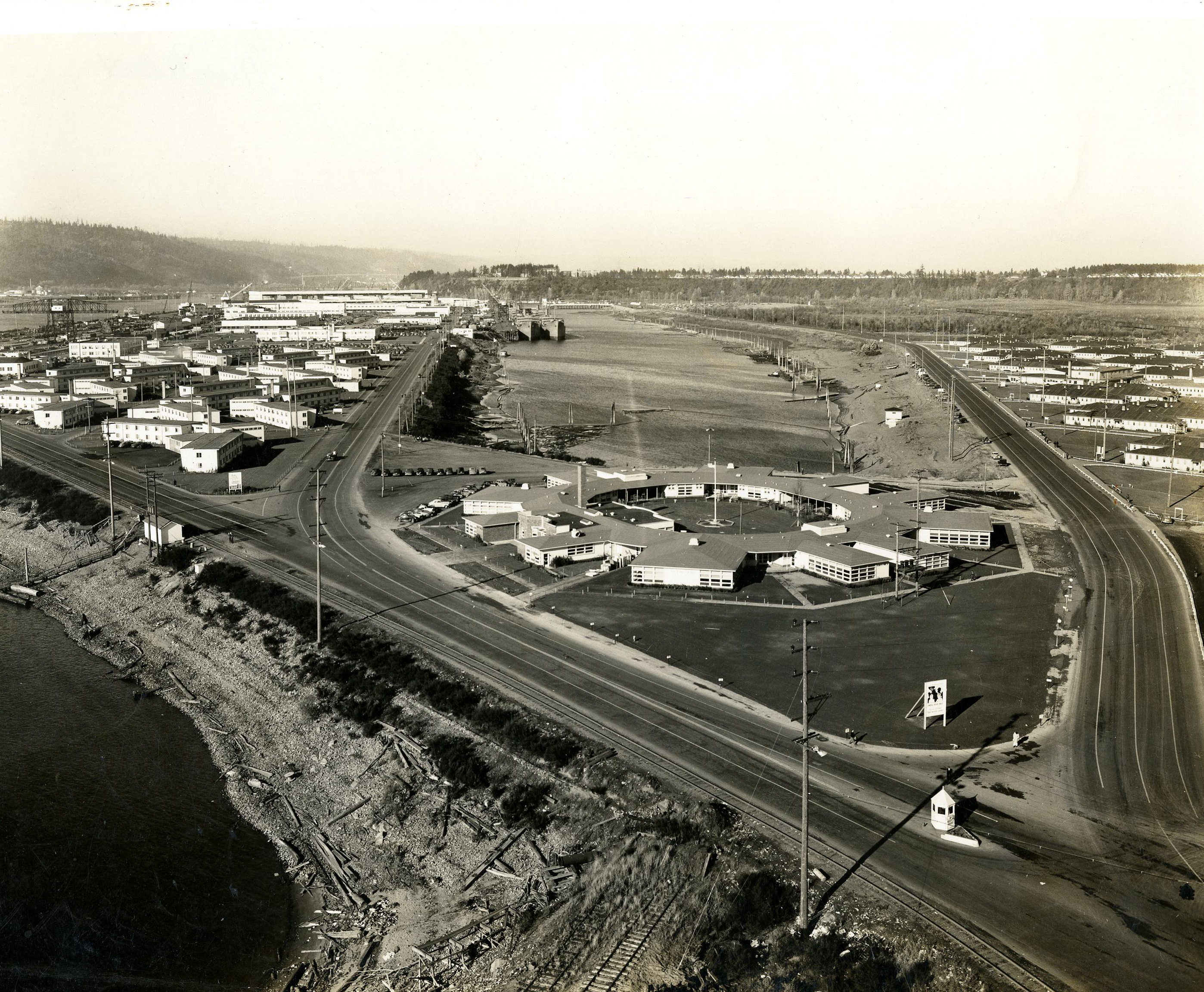 The child care center was built on a thin piece of land linking Swan Island to the eastern shore of the Willamette River. The distinctive "spokes" of the classrooms are apparent in this aerial photograph. Parents could drop their children off at the center before joining the check-in line at the shipyards, and pick them back up on their way back to the wartime housing developments nearby.